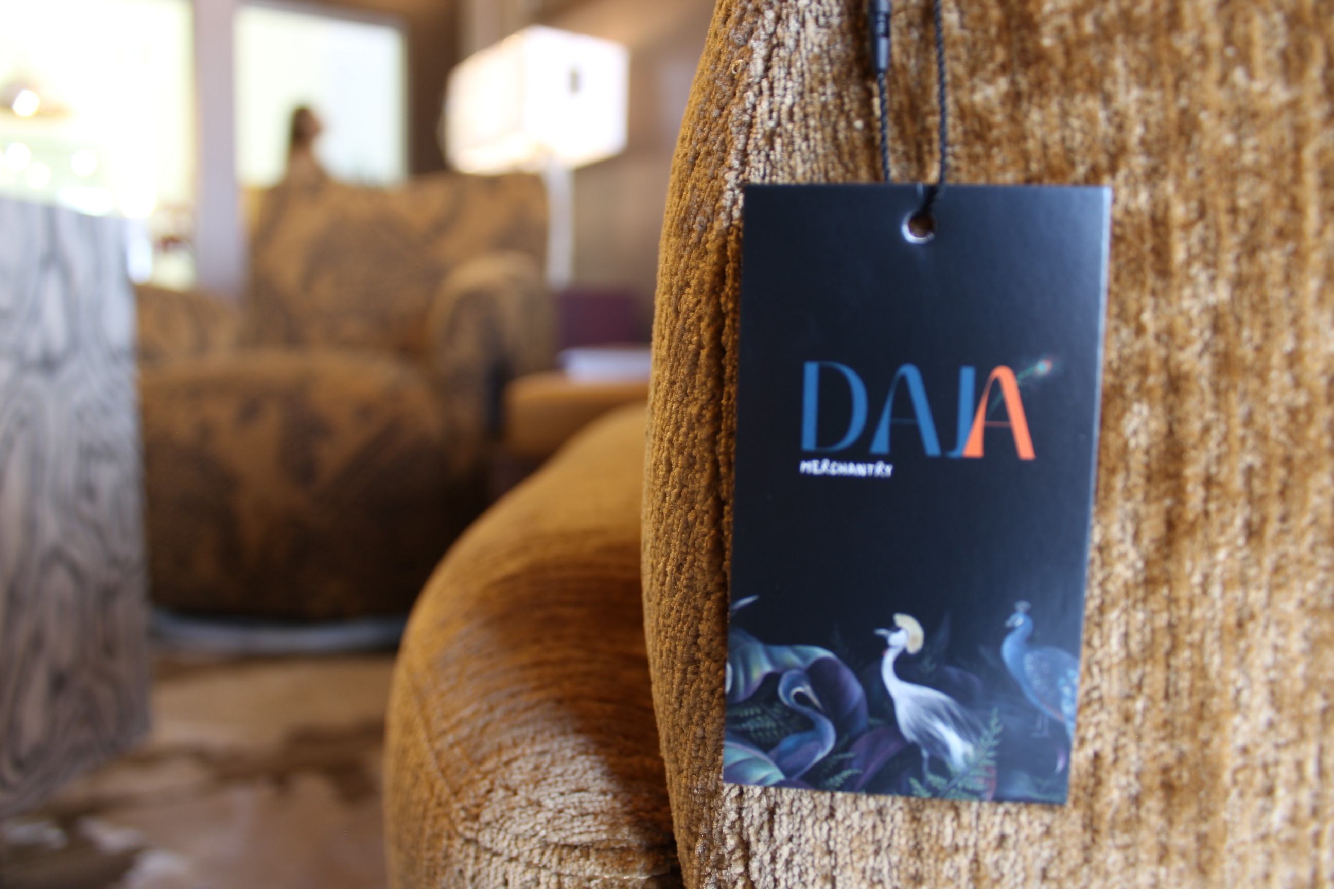A close view of textured upholstery and a Daja furniture tag