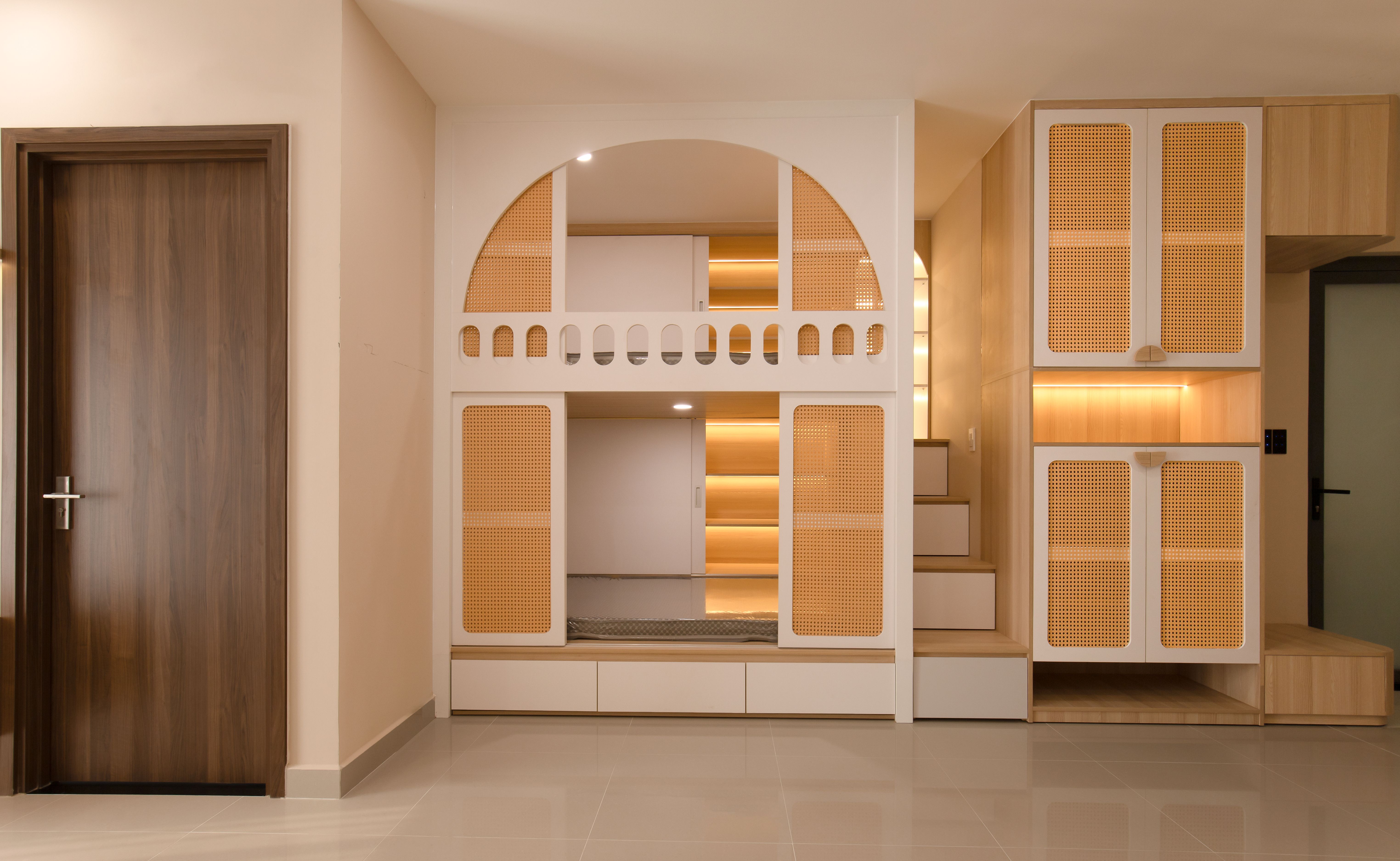 An architectural interior with warm wood, cane panels, and softly lit arches