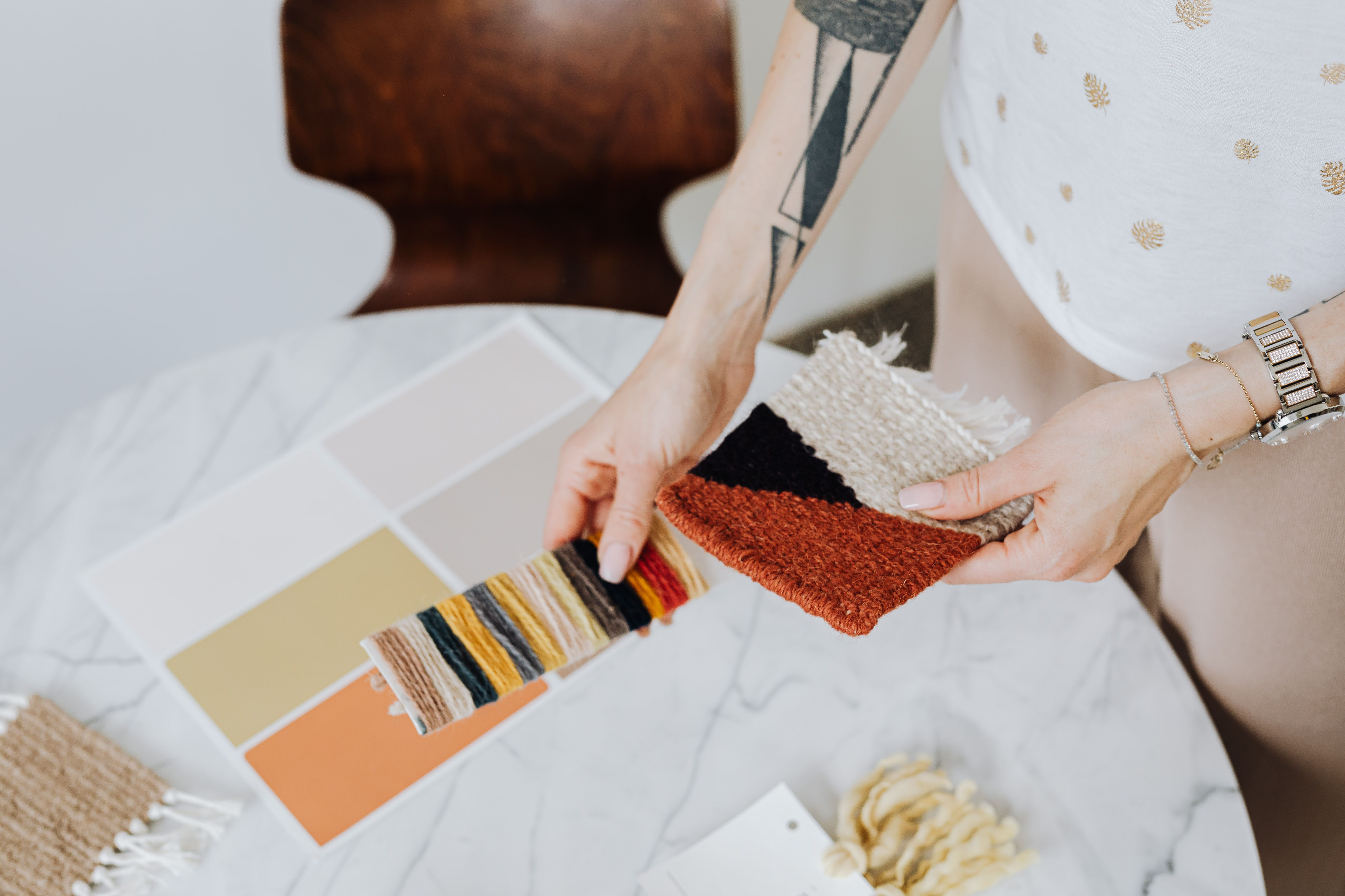 A designer comparing fabric textures and color samples
