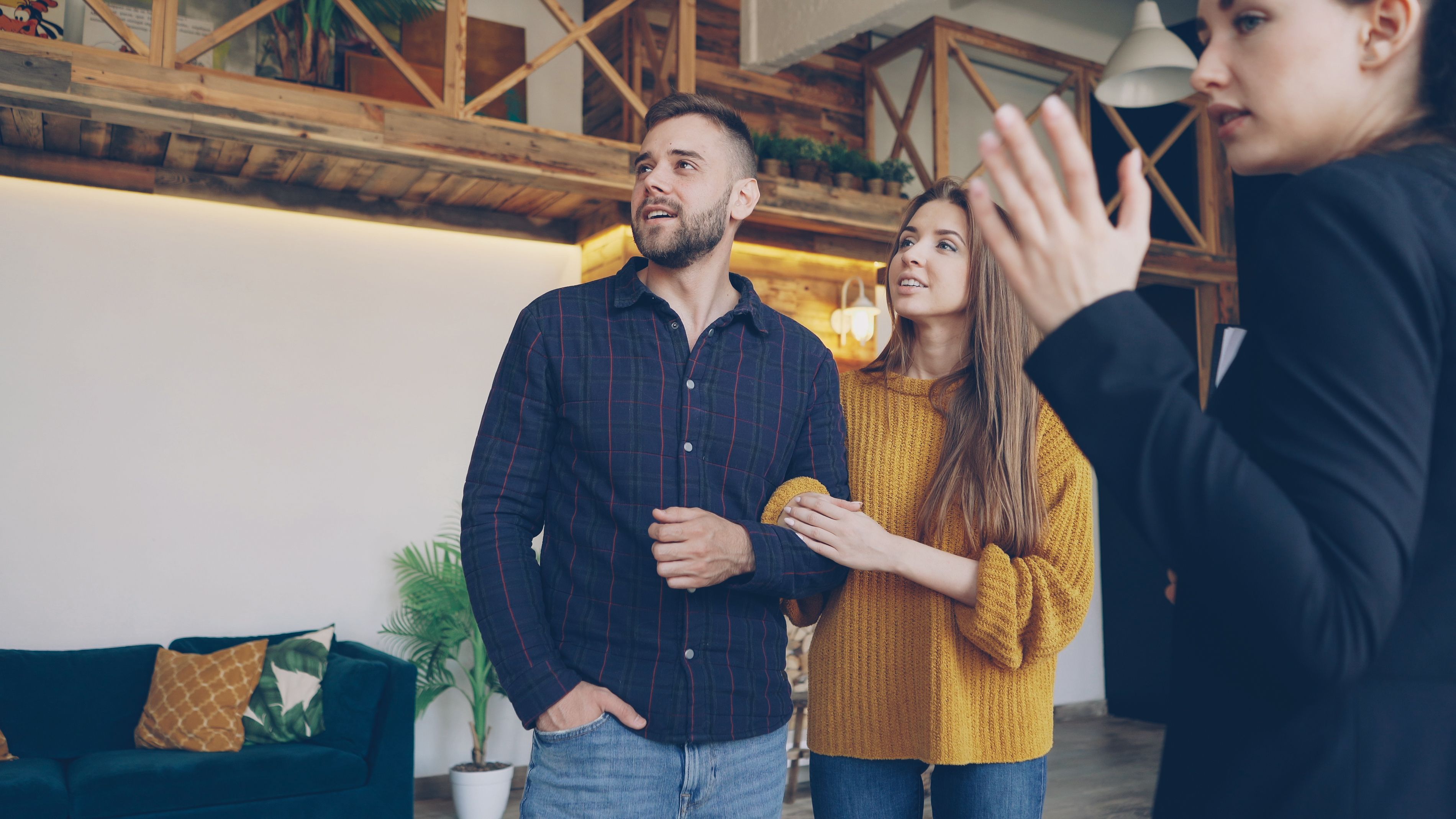 A designer listening to a couple during a home consultation