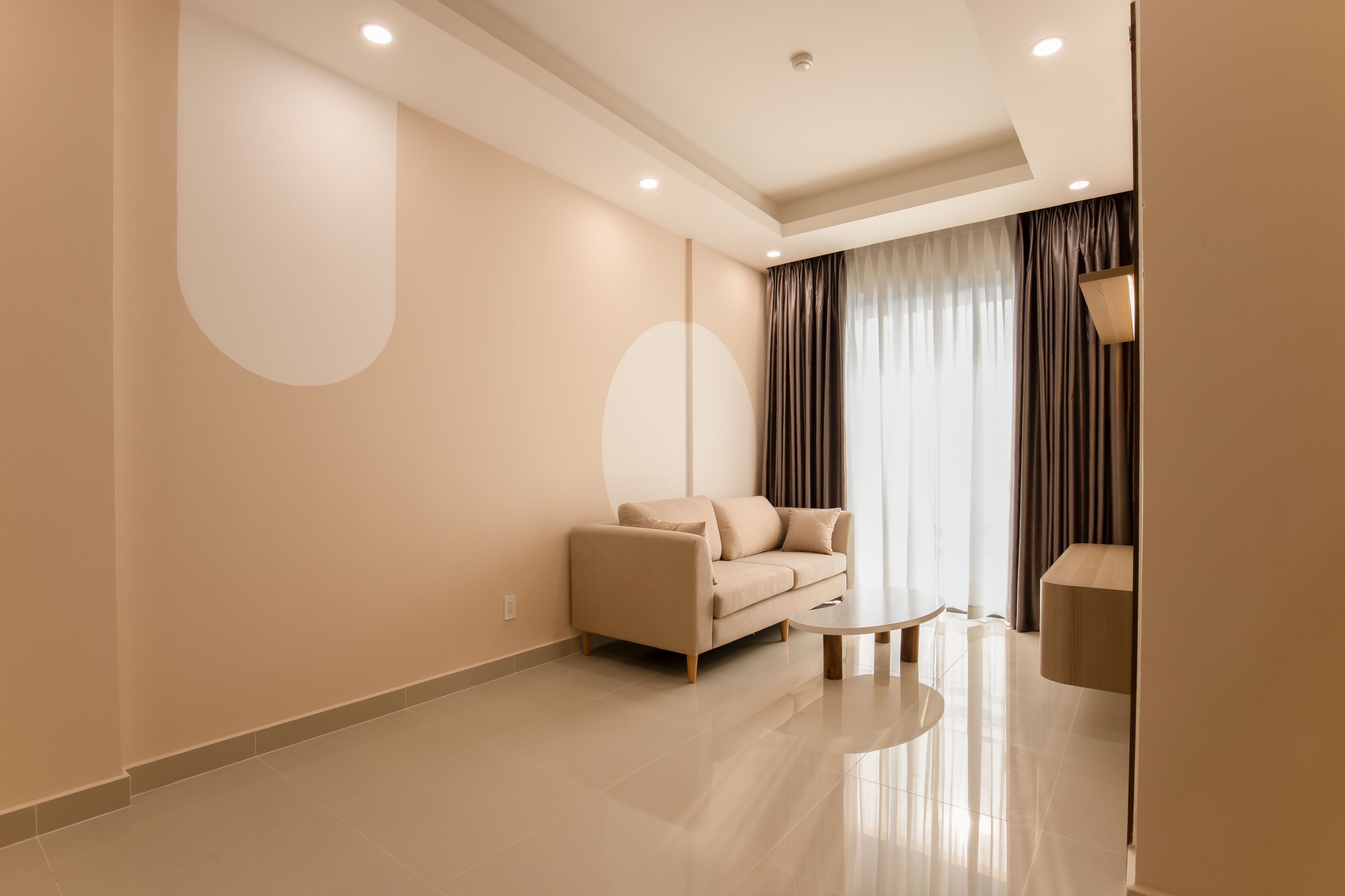 A finished living room with sculptural furniture and layered materials